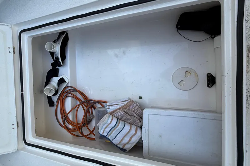 Slide: The Image of Storage compartment of 2022 Dorado 25 Flat Deck boat with equipment and accessories. - 27