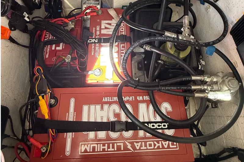 Slide: The Image of Battery compartment of 2022 Dorado 25 Flat Deck with Dakota Lithium batteries and wiring. - 32
