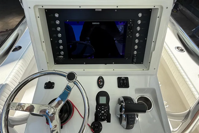 Slide: The Image of 2022 Dorado 25 Flat Deck boat console with steering wheel and navigation controls. - 35