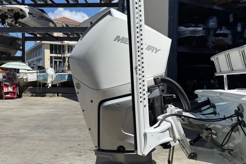 Slide: The Image of 2022 Dorado 25 Flat Deck boat with Mercury engine in a marina setting. - 5