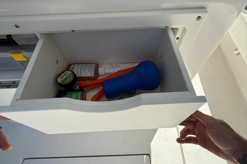 Slide: The Image of Open drawer on 2022 Dorado 25 Flat Deck boat with various items inside. - 50
