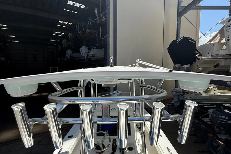 Slide: The Image of 2022 Dorado 25 Flat Deck boat with stainless steel rod holders in a storage facility. - 57