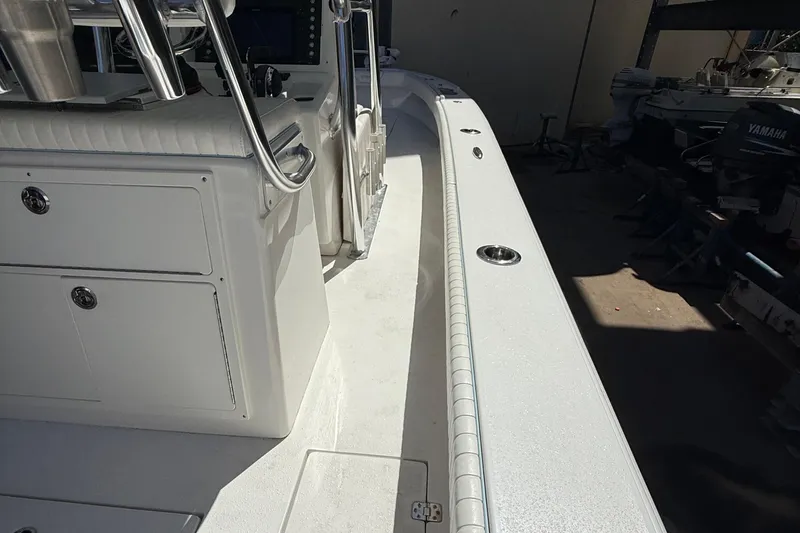 Slide: The Image of 2022 Dorado 25 Flat Deck boat interior with storage compartments and stainless steel fixtures. - 58