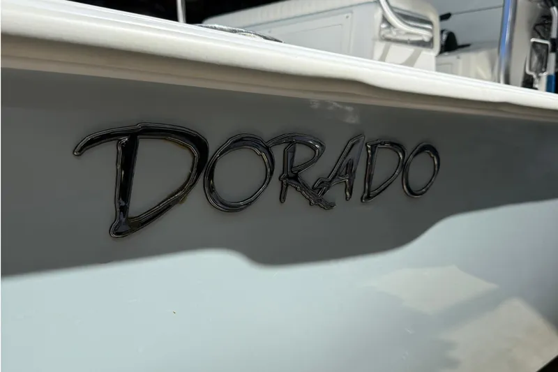 Slide: The Image of 2022 Dorado 25 Flat Deck boat logo on side panel. - 6