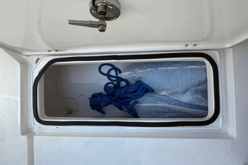 Slide: The Image of Storage compartment on 2022 Dorado 25 Flat Deck boat with blue rope inside. - 60