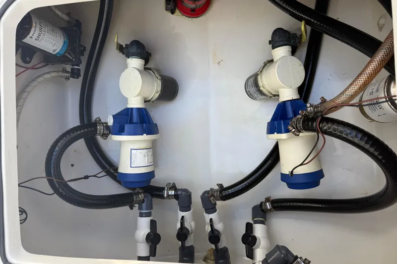 Slide: The Image of 2022 Dorado 25 Flat Deck boat plumbing system with pumps and hoses. - 62