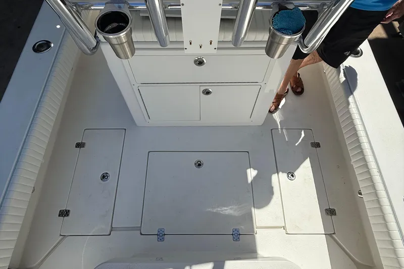 Slide: The Image of 2022 Dorado 25 Flat Deck boat interior with storage compartments and rod holders. - 64