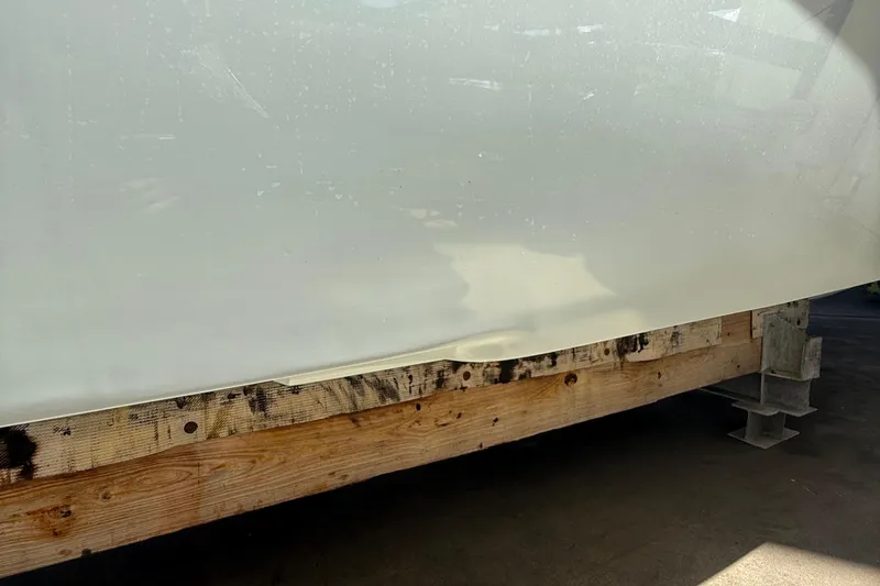 Slide: The Image of 2022 Dorado 25 Flat Deck boat hull on wooden support. - 9