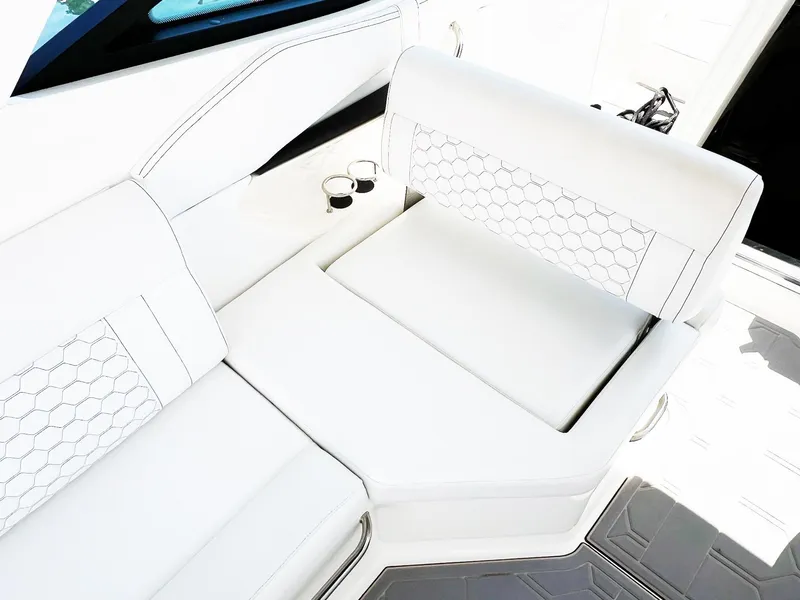 Slide: The Image of 2019 Sea Ray Sundancer 320 Outboard interior with white seating and cup holders. - 10