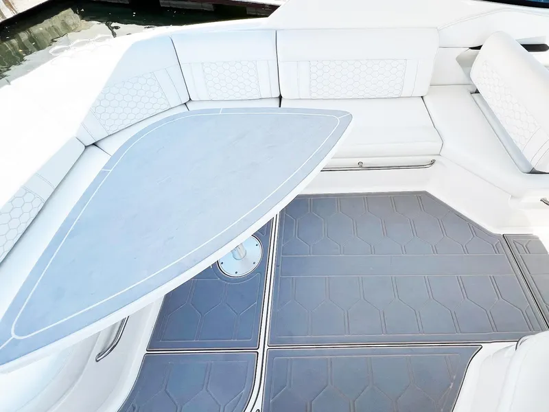 Slide: The Image of 2019 Sea Ray Sundancer 320 Outboard interior with sleek seating and modern table design. - 13