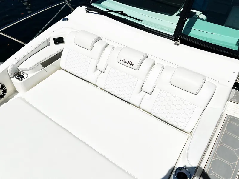Slide: The Image of 2019 Sea Ray Sundancer 320 Outboard, white cushioned seating area, luxury boat interior. - 15