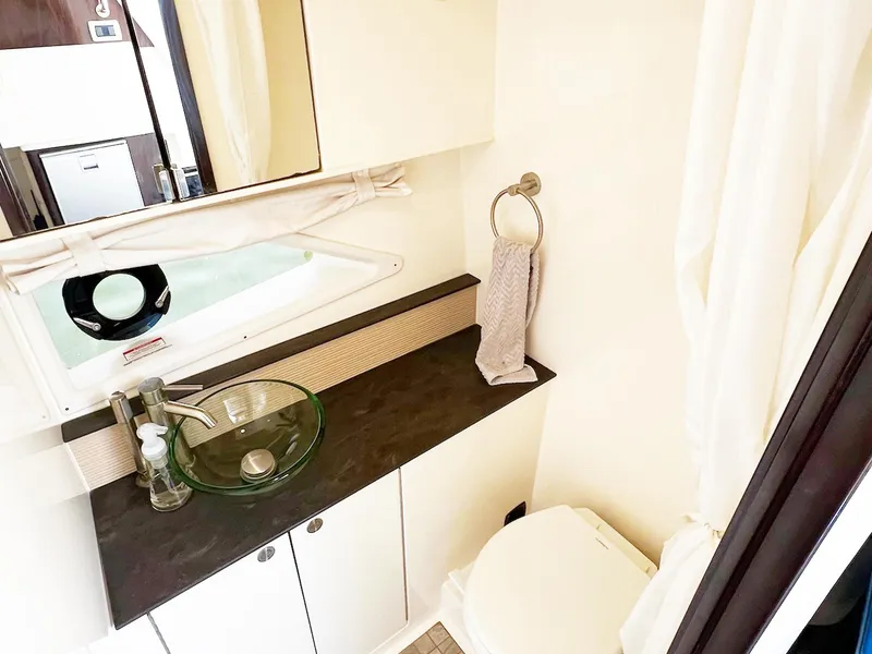 Slide: The Image of 2019 Sea Ray Sundancer 320 Outboard bathroom with modern sink and toilet. - 24