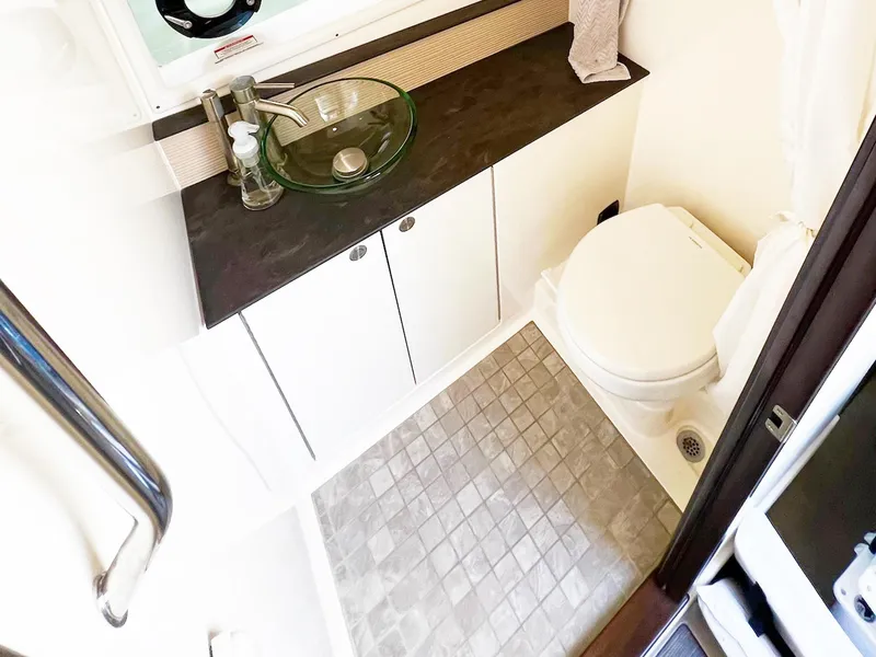 Slide: The Image of 2019 Sea Ray Sundancer 320 Outboard bathroom with modern sink and toilet. - 25