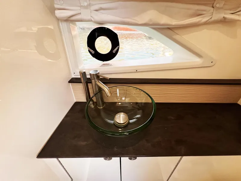 Slide: The Image of 2019 Sea Ray Sundancer 320 Outboard bathroom with modern glass sink and sleek faucet. - 26