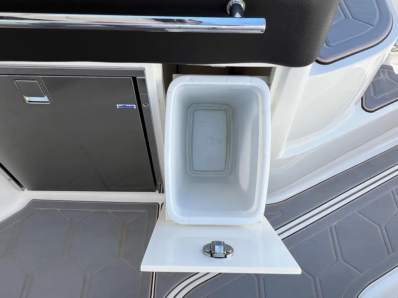 Slide: The Image of 2019 Sea Ray Sundancer 320 Outboard interior with open storage compartment and sleek flooring. - 28