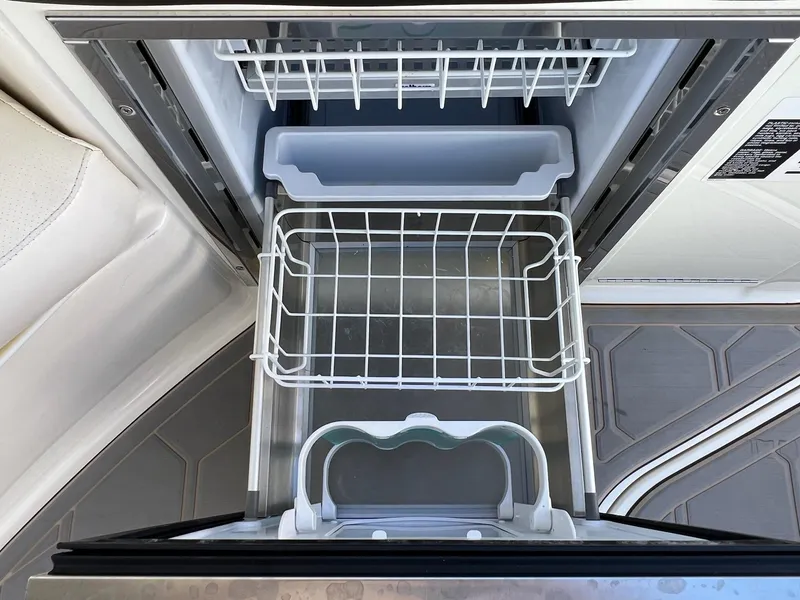 Slide: The Image of Open refrigerator on 2019 Sea Ray Sundancer 320 Outboard boat, showing interior shelves and compartments. - 29