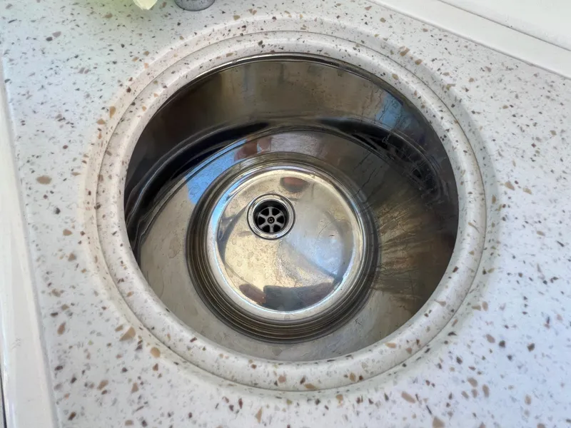 Slide: The Image of Stainless steel sink on 2019 Sea Ray Sundancer 320 Outboard boat with speckled countertop. - 31