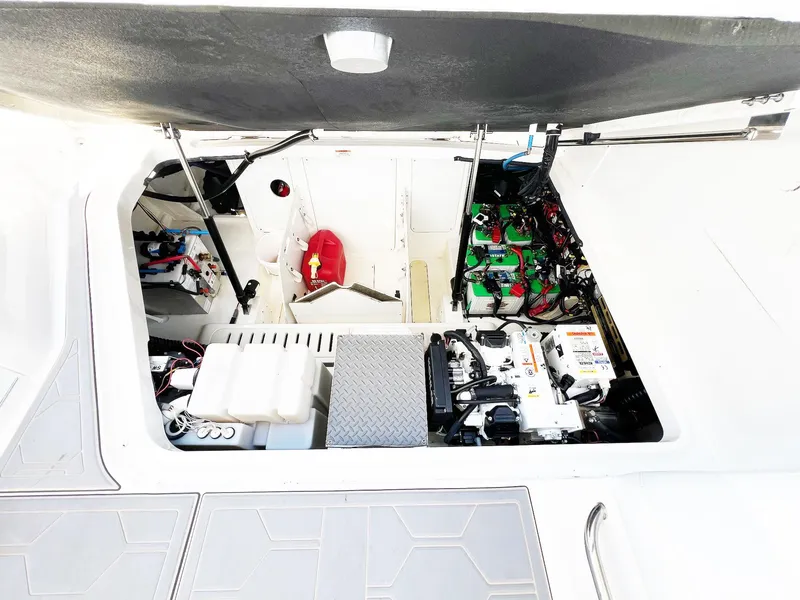 Slide: The Image of Engine compartment of 2019 Sea Ray Sundancer 320 Outboard, showcasing batteries and equipment. - 46