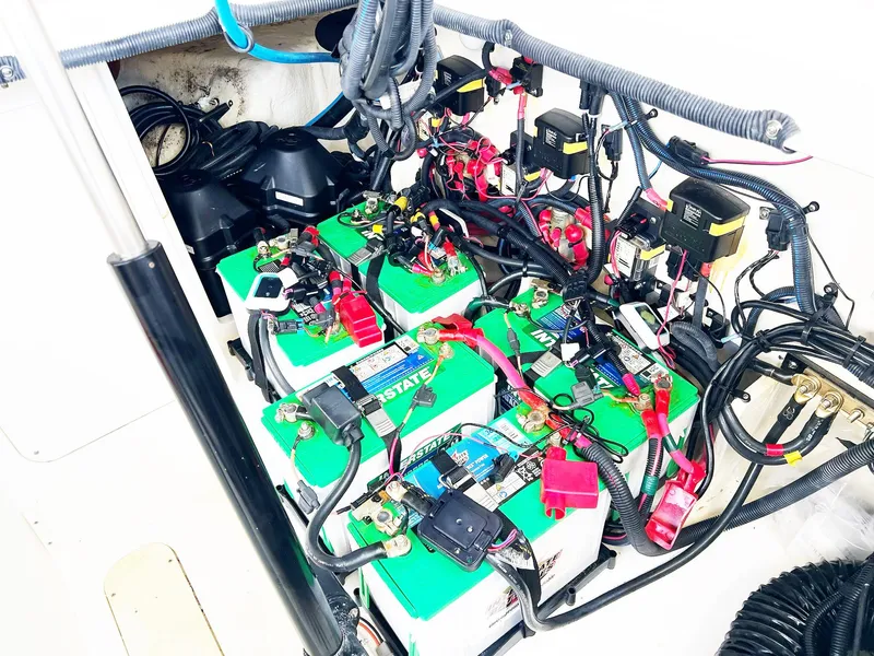 Slide: The Image of Battery compartment of a 2019 Sea Ray Sundancer 320 Outboard, showcasing wiring and connections. - 47