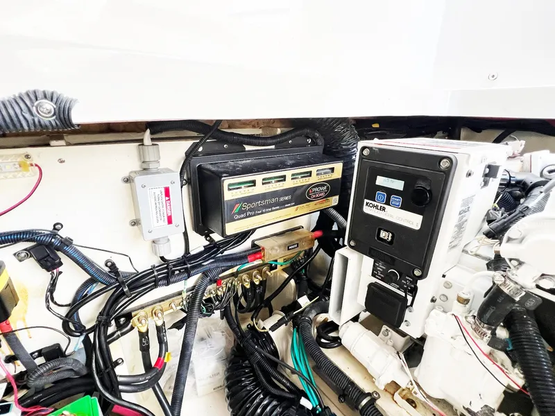 Slide: The Image of Engine compartment of 2019 Sea Ray Sundancer 320 Outboard with electrical components and wiring. - 49