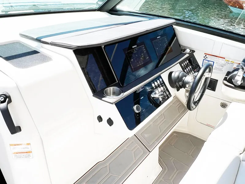 Slide: The Image of 2019 Sea Ray Sundancer 320 Outboard helm with modern controls and navigation displays. - 5