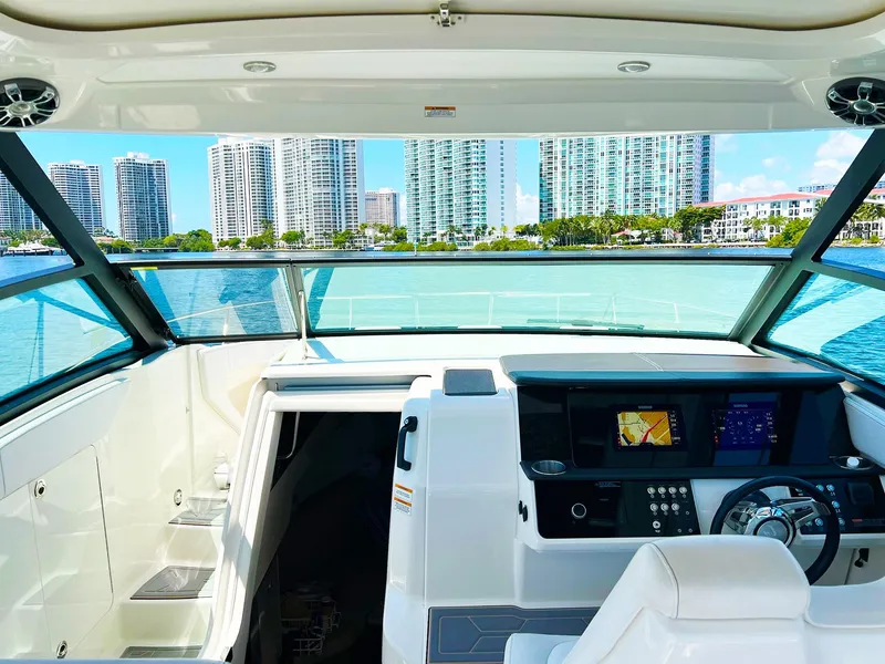 Slide: The Image of 2019 Sea Ray Sundancer 320 Outboard interior with city skyline view. - 6