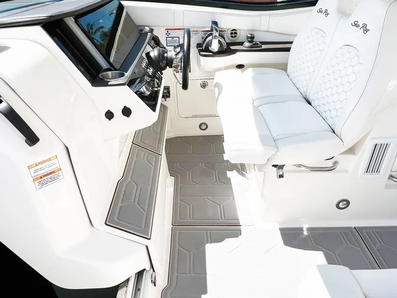 Slide: The Image of 2019 Sea Ray Sundancer 320 Outboard helm with modern controls and luxurious seating. - 8