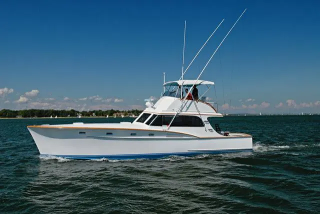 The Image of 1957 Rybovich Convertible yacht cruising on open water under clear blue skies. - 0
