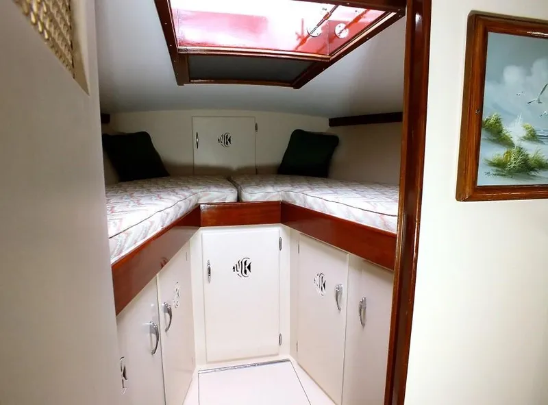Slide: The Image of 1957 Rybovich Convertible cabin interior with twin beds and skylight. - 12