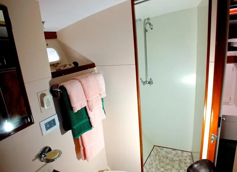 Slide: The Image of 1957 Rybovich Convertible yacht bathroom with shower, towels, and modern fixtures. - 16