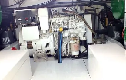 Slide: The Image of Engine room of a 1957 Rybovich Convertible boat, showcasing mechanical components and wiring. - 19