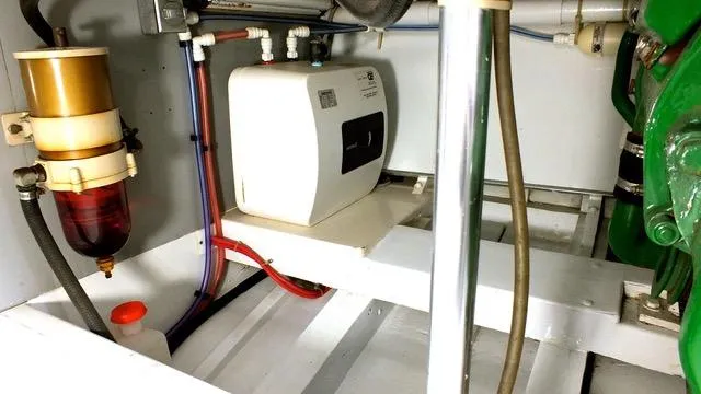 Slide: The Image of Engine room of a 1957 Rybovich Convertible boat, showcasing mechanical components and wiring. - 20