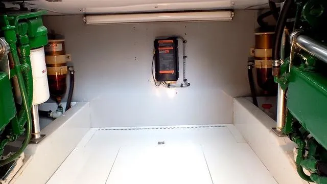 Slide: The Image of 1957 Rybovich Convertible engine room with mechanical components and lighting. - 22