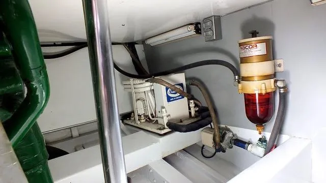 Slide: The Image of 1957 Rybovich Convertible engine room with fuel filter and mechanical components. - 23