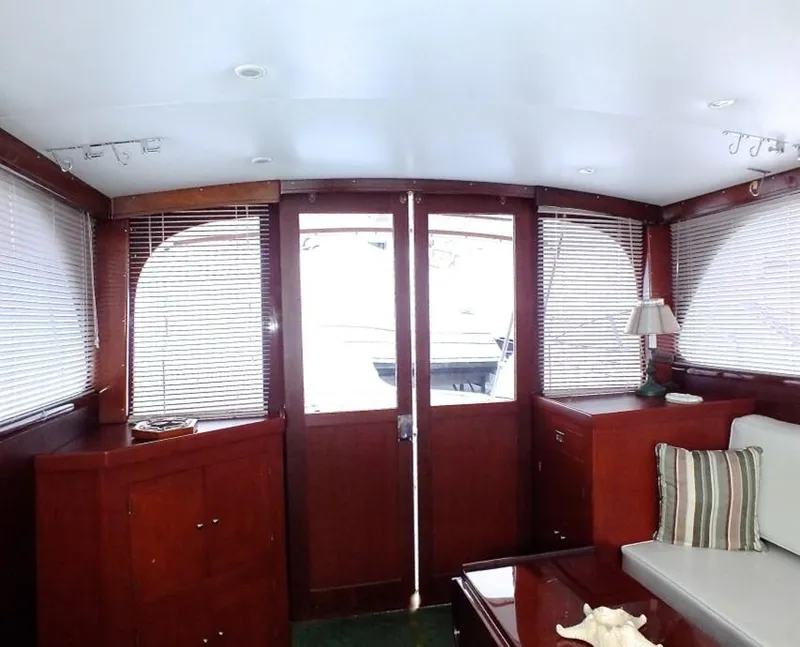 Slide: The Image of Interior of a 1957 Rybovich Convertible yacht with wooden paneling and blinds. - 5
