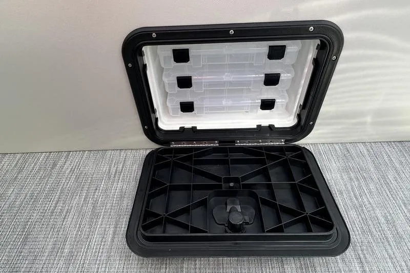 Slide: The Image of 2026 Bennington S 20 SF pontoon boat with sleek black and silver design under a cloudy sky. - 13