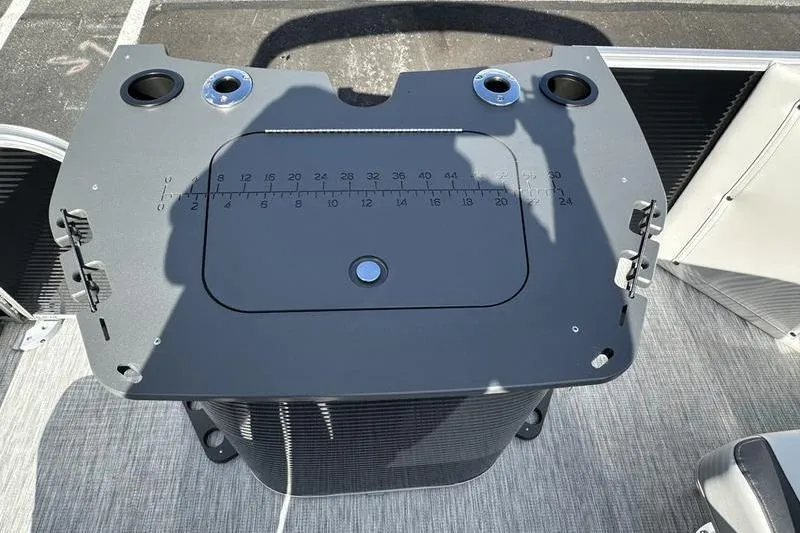 Slide: The Image of 2026 Bennington S 20 SF pontoon boat parked outside a dealership under a sunny sky. - 6