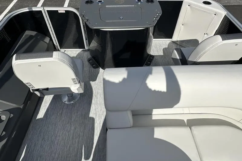 Slide: The Image of 2026 Bennington S 20 SF pontoon boat with sleek design, parked outdoors under blue sky. - 9