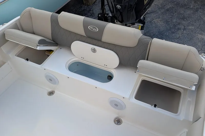 Slide: The Image of 2025 Key West 239 FS boat interior with cushioned seating and storage compartments. - 10