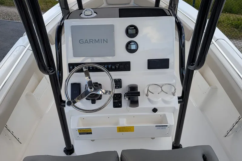 Slide: The Image of 2025 Key West 239 FS boat console with Garmin display and steering wheel. - 15