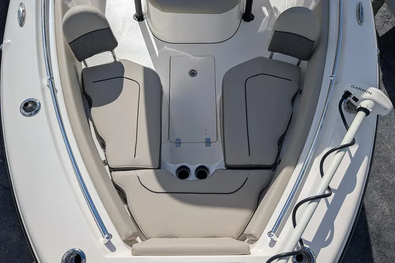 Slide: The Image of 2025 Key West 239 FS boat interior with cushioned seating and Garmin equipment. - 18