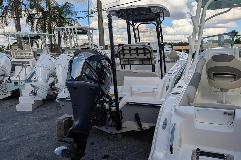 Slide: The Image of 2025 Key West 239 FS boat with Yamaha outboard motor, displayed outdoors. - 2