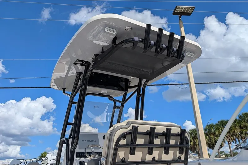 Slide: The Image of 2025 Key West 239 FS boat with T-top and rod holders against blue sky. - 23