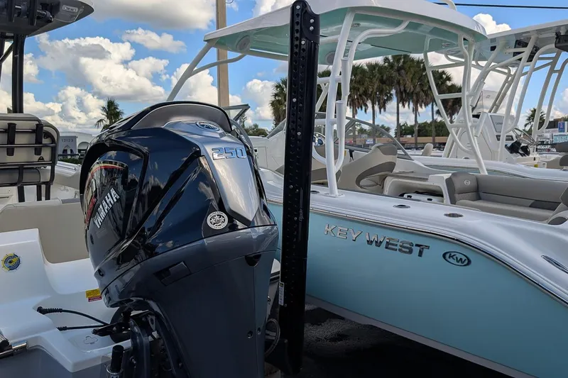 Slide: The Image of 2025 Key West 239 FS boat with Yamaha 250 engine, parked outdoors under blue sky. - 6