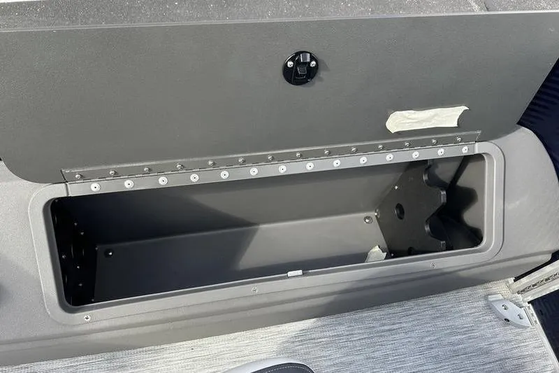 Slide: The Image of Storage compartment on 2026 Bennington 22 SF boat, featuring secure latch and spacious interior. - 19