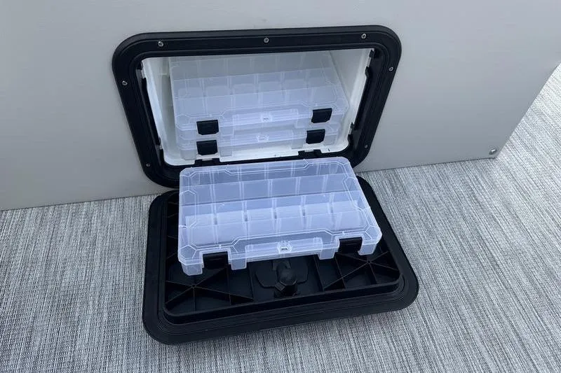 Slide: The Image of Storage compartment with tackle boxes on a 2026 Bennington 22 SF boat. - 22
