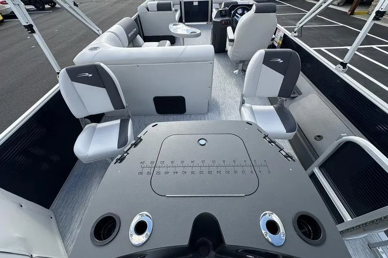 Slide: The Image of 2026 Bennington 22 SF pontoon boat parked outside dealership. - 3
