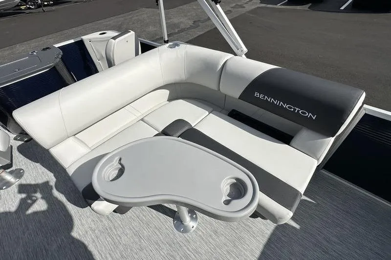 Slide: The Image of 2026 Bennington 22 SF boat interior with gray seating and storage compartments. - 36