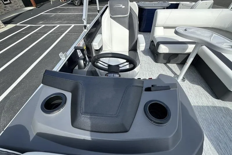 Slide: The Image of 2026 Bennington 22 SF boat interior with steering console and seating area. - 37