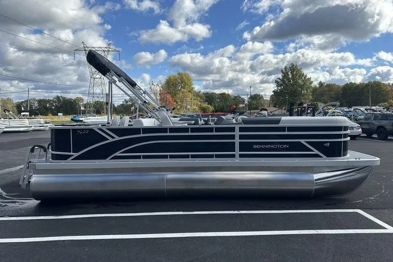 Slide: The Image of 2026 Bennington 22 SF pontoon boat parked outdoors under cloudy sky. - 5
